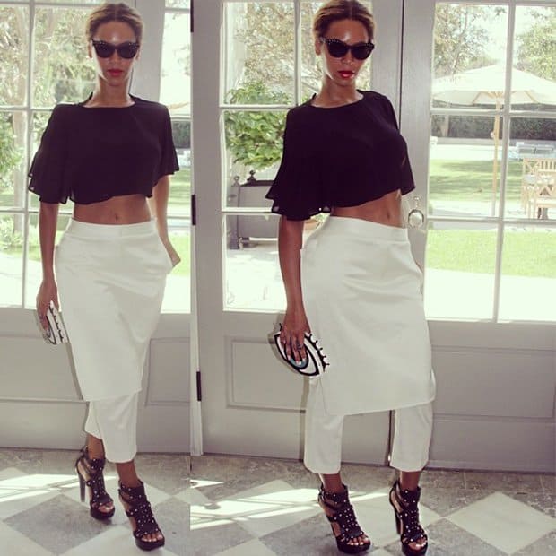 Beyonce wearing a ruffled crop top, 3.1 Phillip Lim pants, studded platform sandals, and a Charlotte Olympia clutch