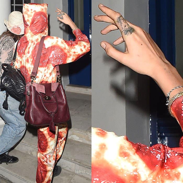 Cara Delevingne's lion finger tattoo gives her away despite wearing a pepperoni pizza-print jumpsuit in London