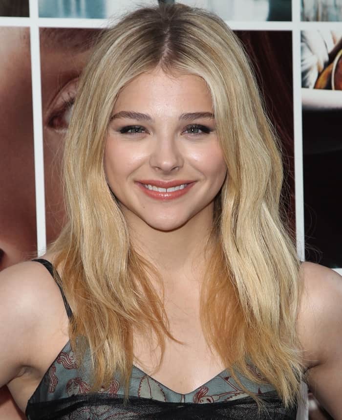 Chloë Grace Moretz looks radiant with her soft, wavy blonde hair, subtle smoky eye makeup, and glossy nude lips at the 'If I Stay' premiere