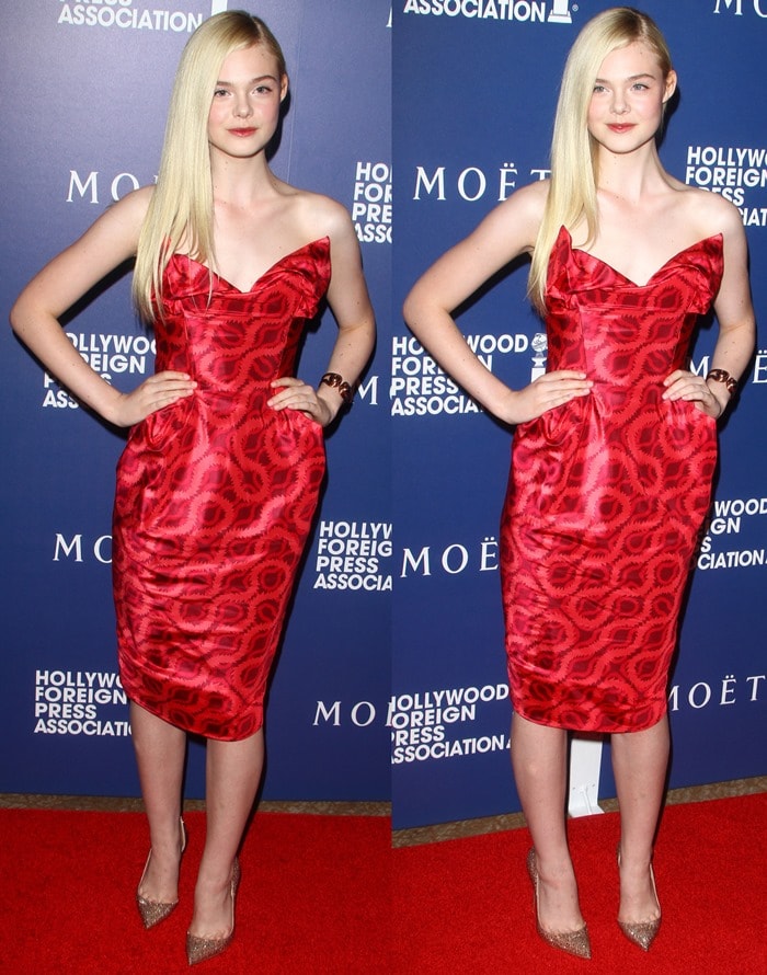 Elle Fanning at the Hollywood Foreign Press Association's Grants Banquet on August 14, 2014, wearing a Vivienne Westwood 'Lilly' double squiggle-print dress and Christian Louboutin Iriza pumps in strass