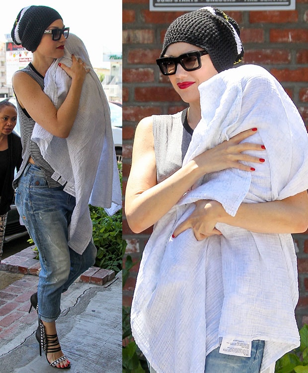 Fashion Forward: Gwen Stefani exudes cool vibes in her baggy G-Star boyfriend jeans paired with a chic monochrome muscle tee, showcasing her toned arms