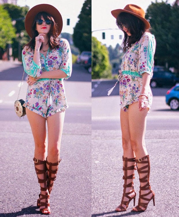 Kacie Cone flaunts her legs in a floral romper, a hat, and knee-high gladiator sandals