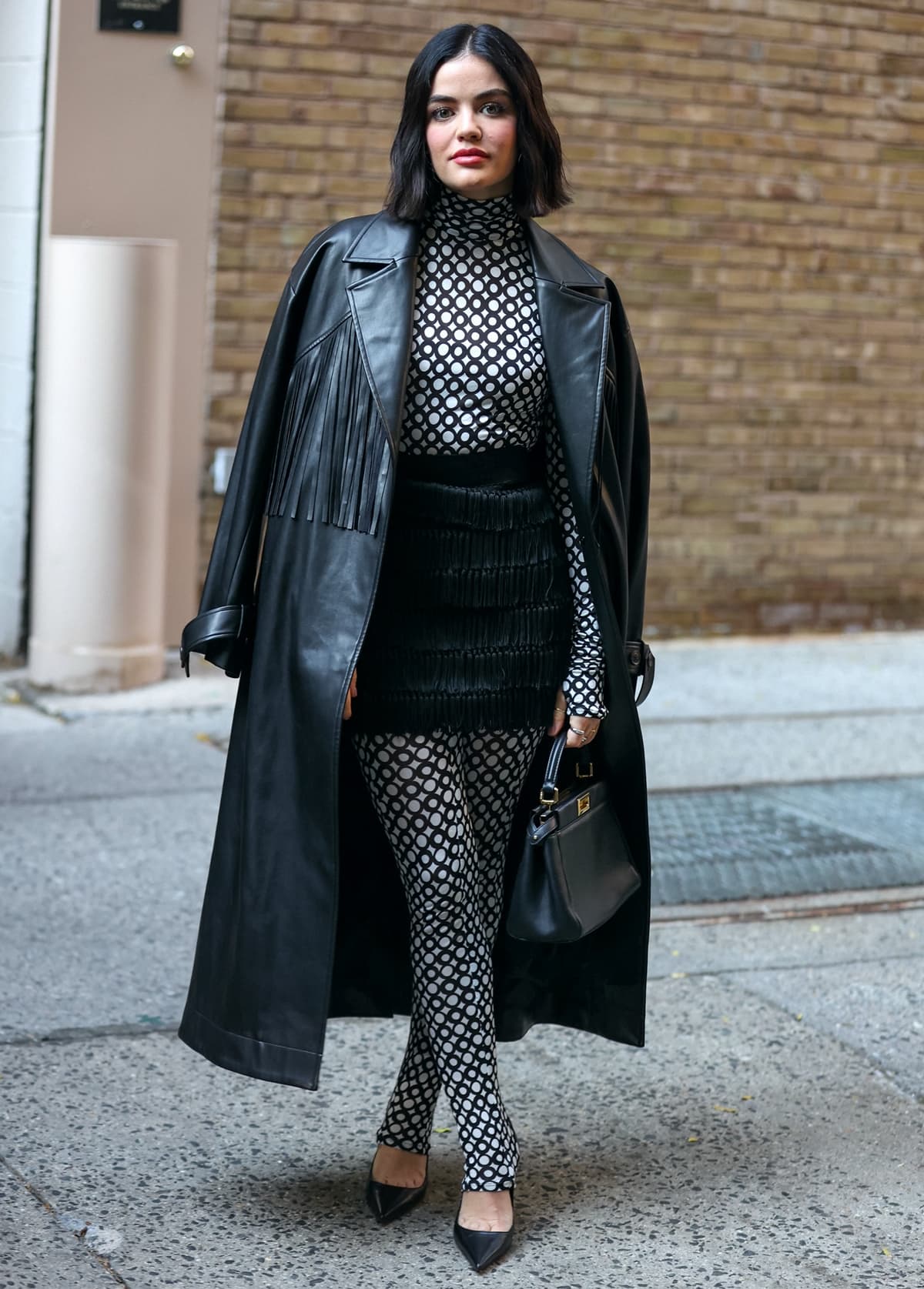 Lucy Hale's classic black coat from Jason Wu heads in a Western direction with its swingy fringe, while the faux leather fabrication delivers all the buttery goodness of the real thing