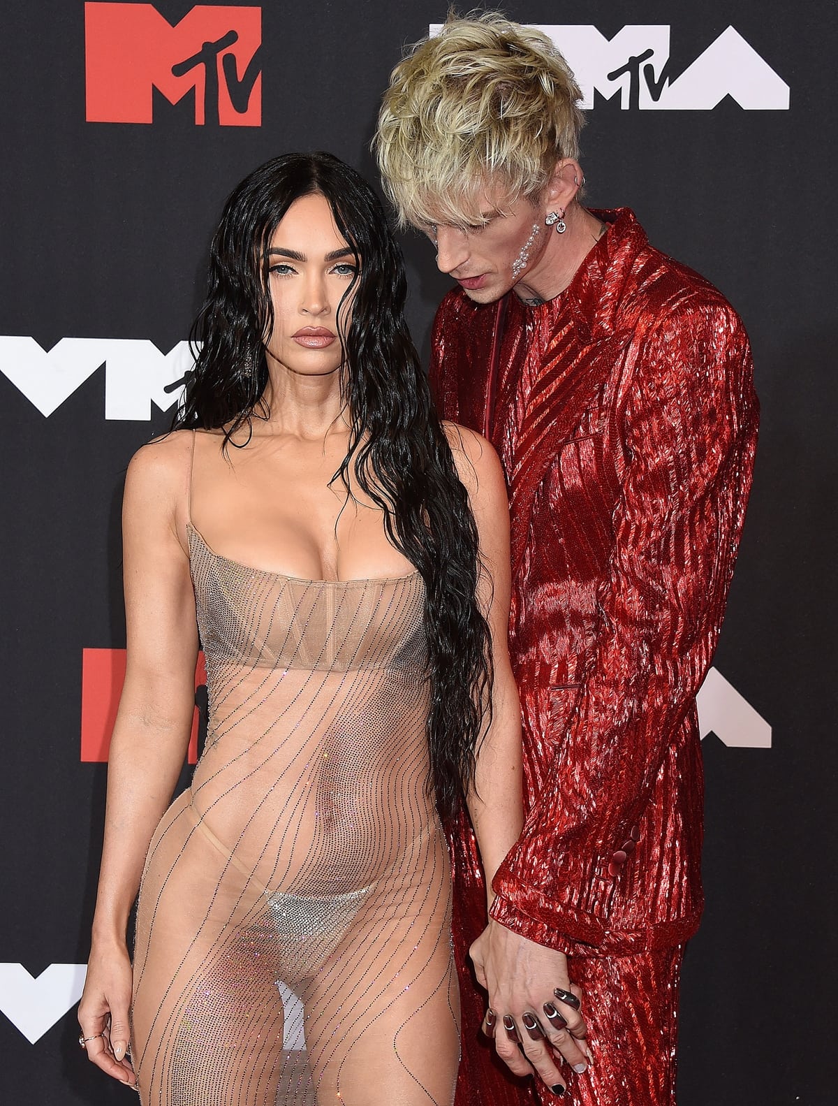 Machine Gun Kelly checking out her girlfriend Megan Fox's naked dress and embellished thong at the 2021 MTV Video Music Awards