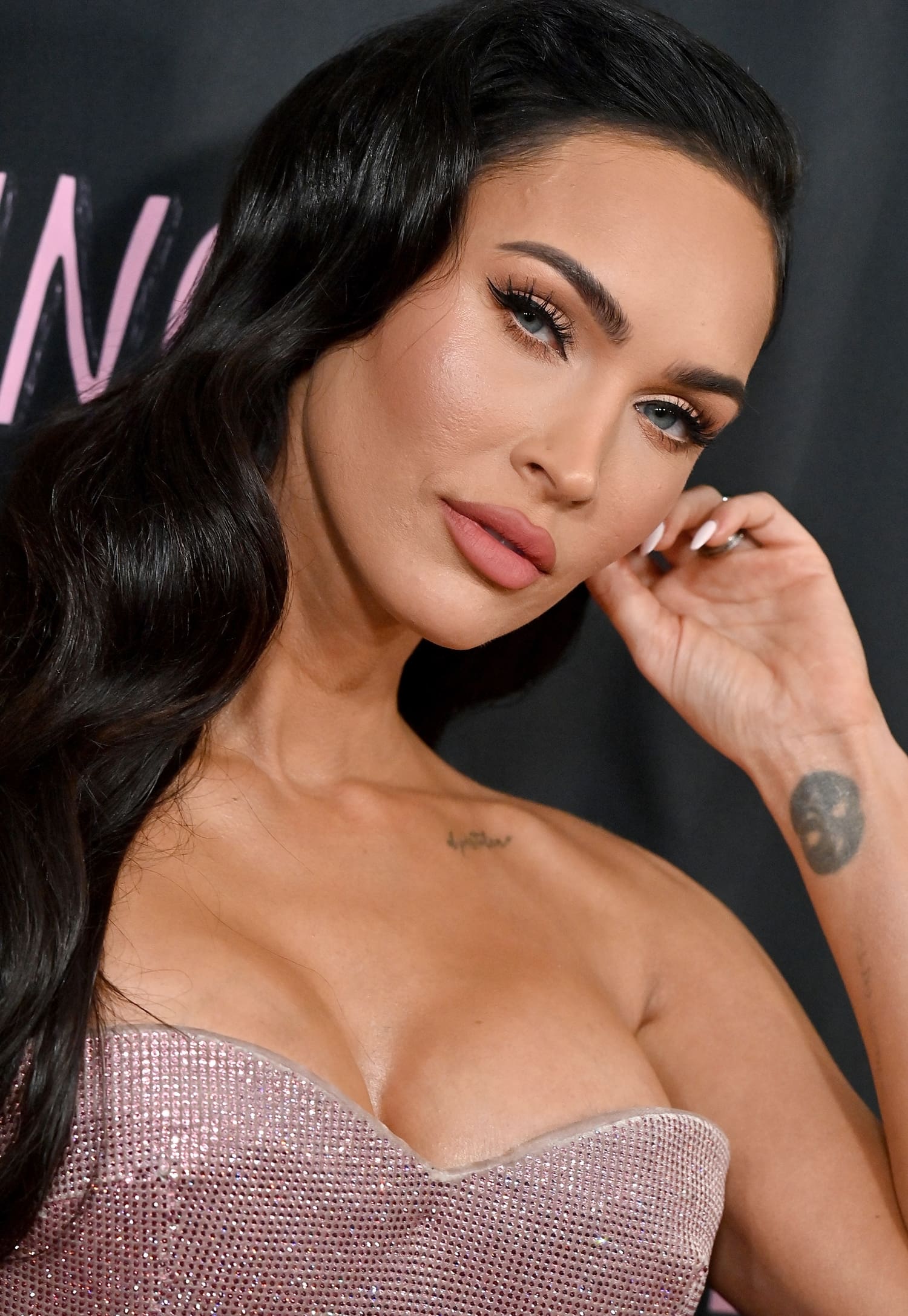 Megan Fox shows off her ‘el pistolero’ collarbone tattoo and her yin-yang symbol wrist tattoo