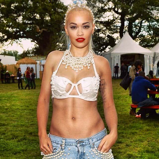 Rita Ora shows off her pearl-embellished denim and bra ensemble backstage at the 2014 V Festival