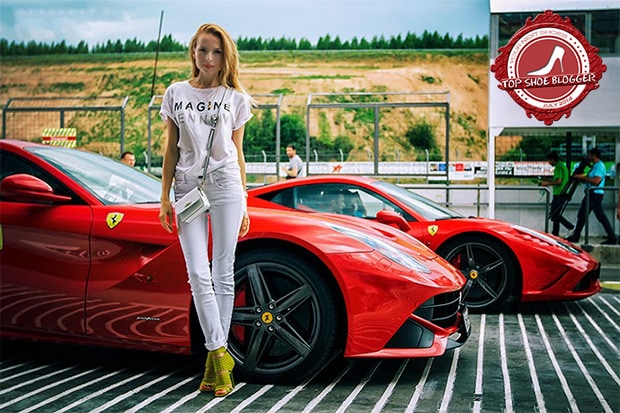 Tini Tani posing with a luxurious Ferrari car in the background