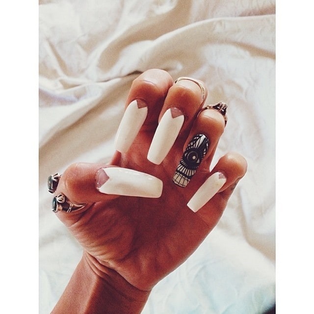 Vanessa Hudgens showcases her intricate white nail art with geometric designs and a striking black accent nail