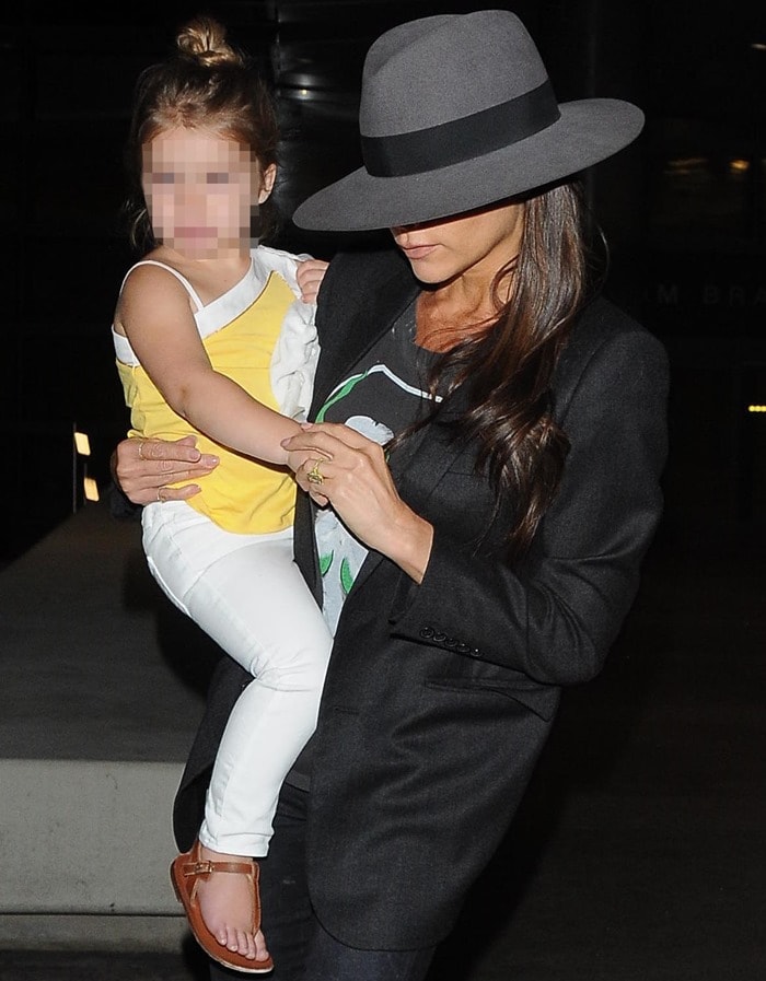 Victoria Beckham carrying daughter Harper at Los Angeles International Airport (LAX) on July 18, 2014