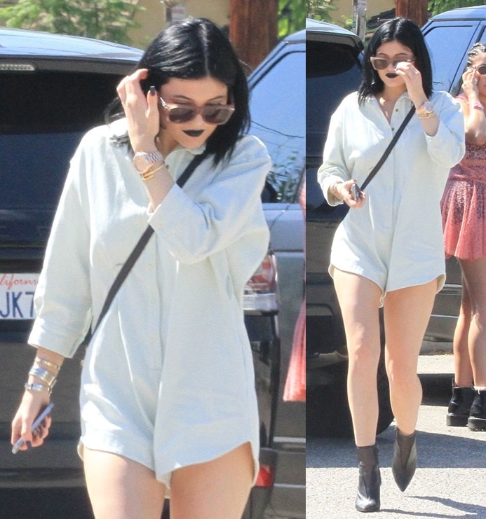 Kylie Jenner wearing a collared romper that looks like a man's shirt from a distance