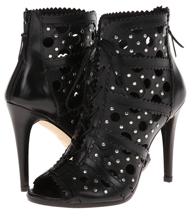 A lively mix of cutouts, appliqués;, and studs lend a frenetic feel to peep-toe Stuart Weitzman booties