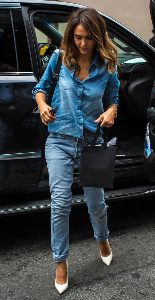 Jessica Alba flaunts her legs in a Current/Elliott oversized trucker denim jacket styled with tights, a midi dress, and booties