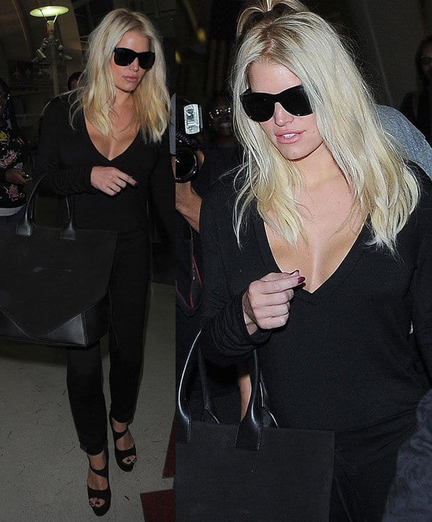 Jessica Simpson arrives at LAX in a sleek all-black outfit, accessorized with oversized sunglasses and a Givenchy handbag