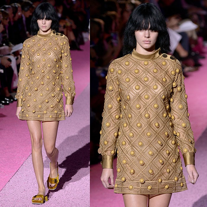 Kendall Jenner embracing Marc Jacobs’ bold, textured mini dress with statement embellishments and matching chunky sandals on the runway