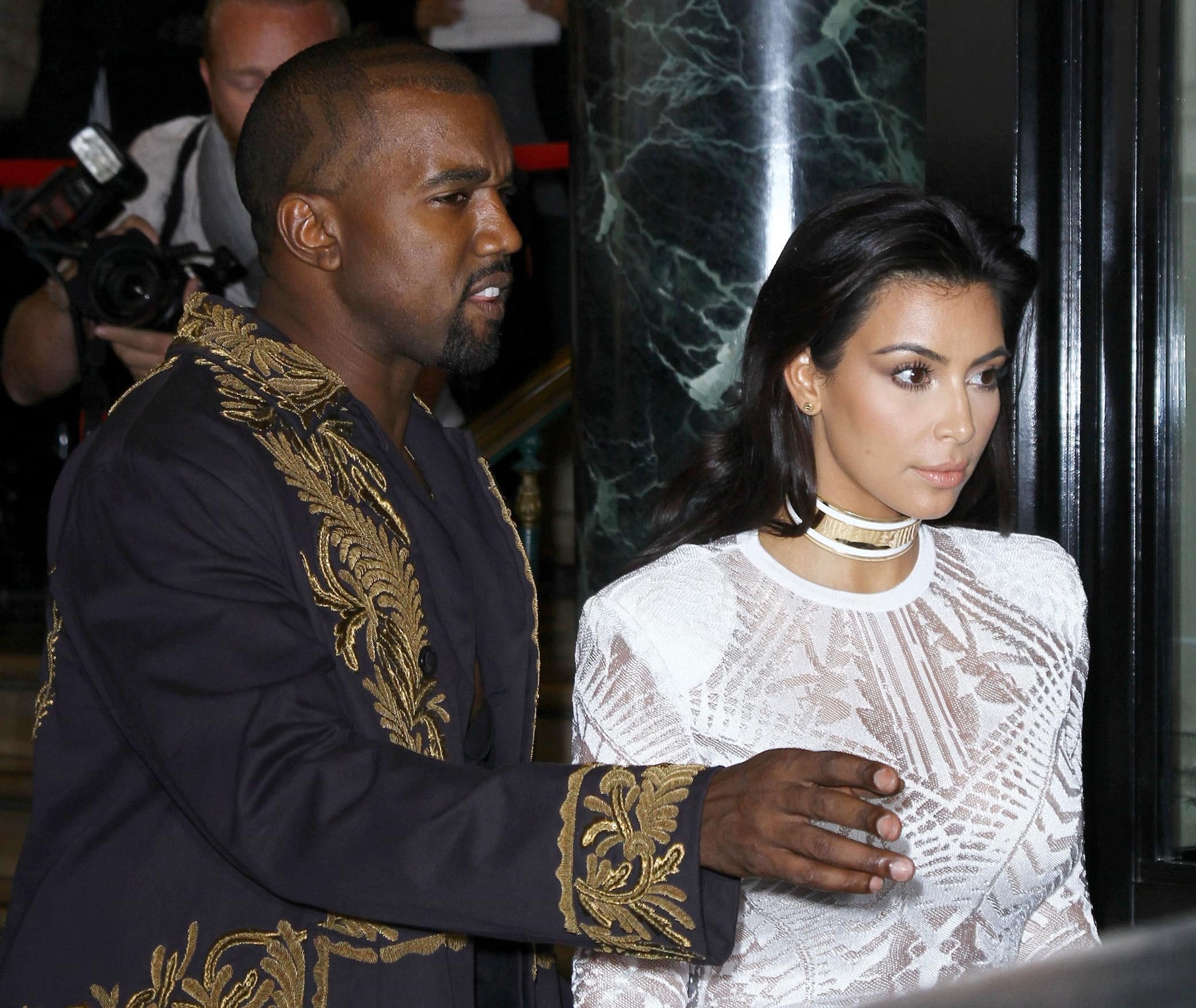 Kim Kardashian styled her white dress with a white-and-gold metallic Balmain choker