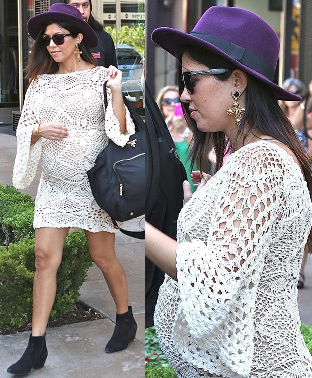 Kourtney Kardashian exuded boho-chic vibes while leaving the American Girl store at The Grove in Los Angeles on September 14, 2014, wearing a cream crochet dress, a statement H&M plum wool hat, black suede ankle boots, and carrying a practical Prada baby bag