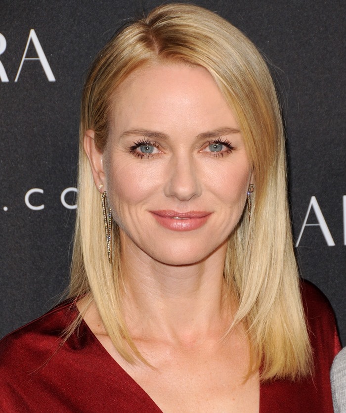 Naomi Watts stuns in a chic red wrap dress, keeping her look elegant and polished at the Altuzarra for Target event during New York Fashion Week