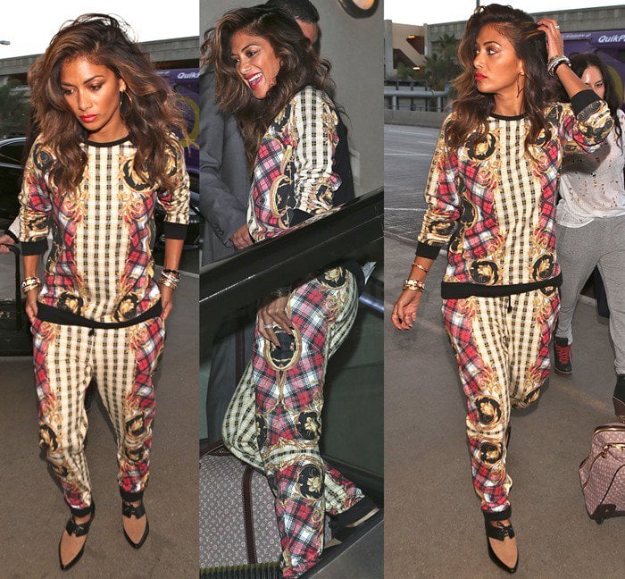 Nicole Scherzinger arrives at LAX in a mixed-print sweater-and-pant combination