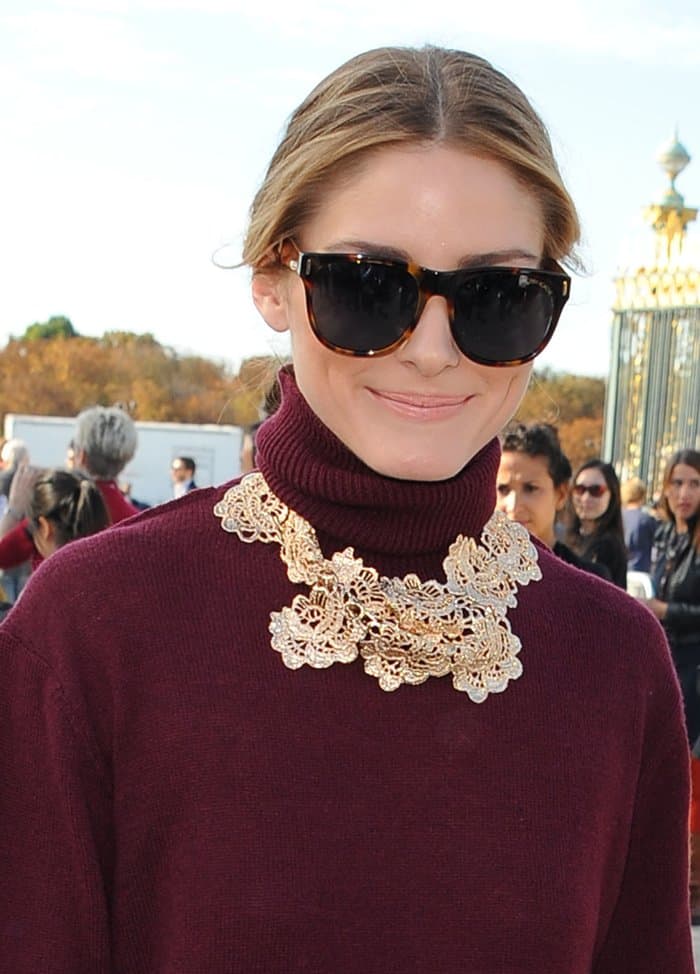 Olivia Palermo styled her Bordeaux dress with a gold flower-patterned statement necklace