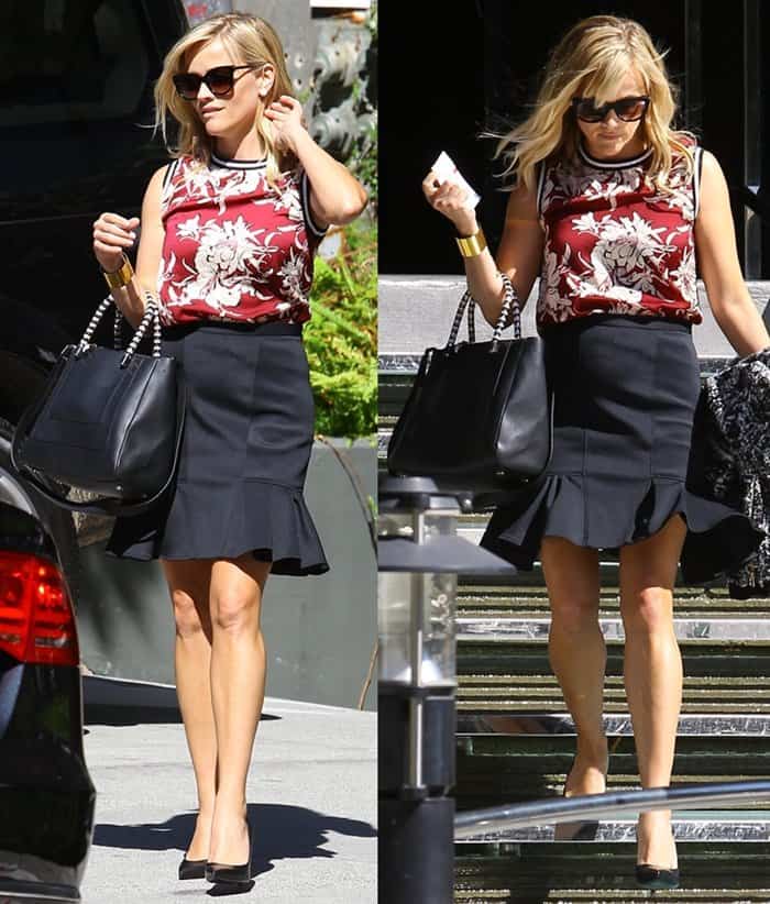Reese Witherspoon turns heads outside the W Hotel in Los Angeles on September 5, 2014, showcasing her legs in classic black Saint Laurent pumps paired with a ruffled-hem skirt and a bold red floral-print top for a polished, feminine look