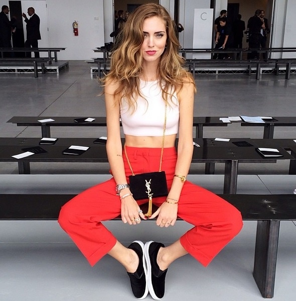 Chiara Ferragni wears her very own velvet slip-on sneakers with a crop top and trousers