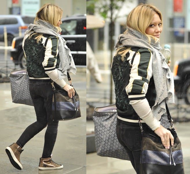 Hilary Duff wears Golden Goose leopard suede slide sneakers and carries a Proenza Schouler python and leather bucket bag and a Goyard St Louis tote