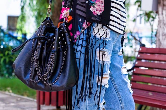 Kristina carries a studded bucket bag