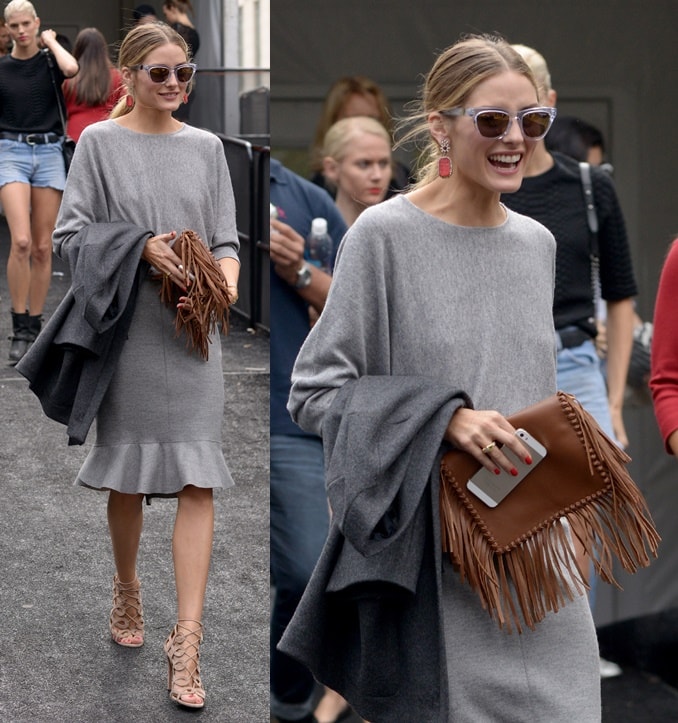 Olivia Palermo accessorized with Westward Leaning sunglasses, orange-red drop earrings, and a gold cuff bracelet