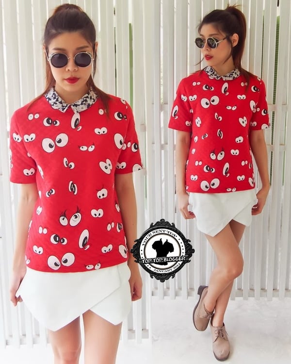 Ramida wears a red cartoon-print top