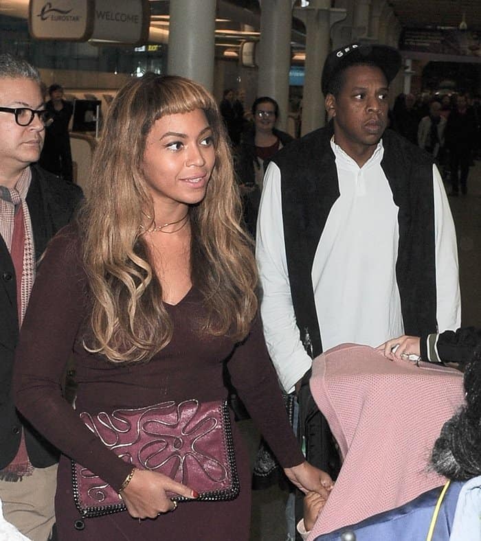 Pictured with her husband Jay Z, Beyonce wears a gold Ash + Ames choker at St. Pancras in London