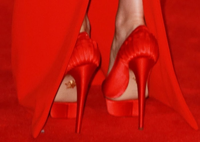 Lily Collins in red satin platform pumps from Charlotte Olympia featuring signature island 38 mm platforms and 152 mm heels