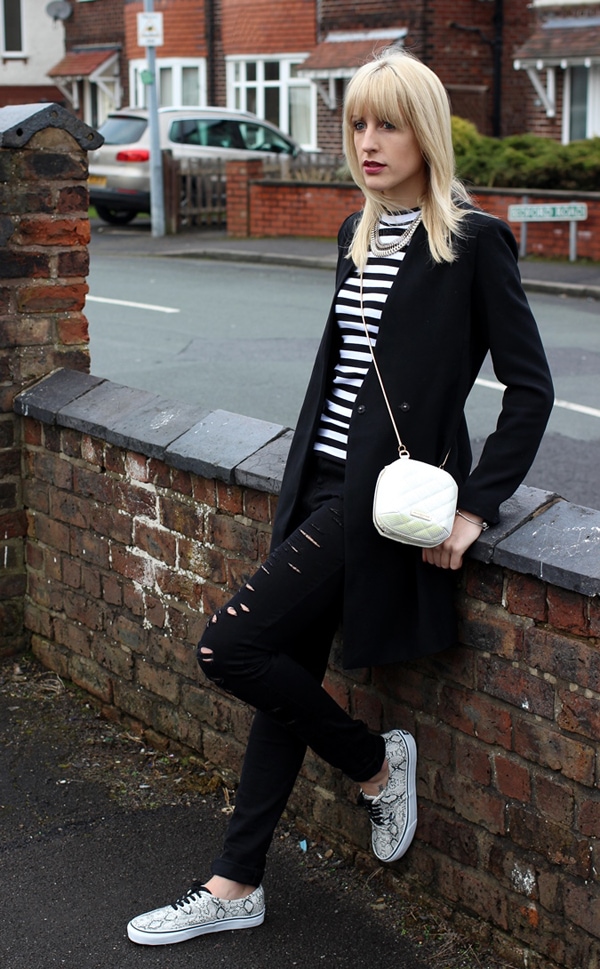 Charlotte in a striped top and distressed jeans