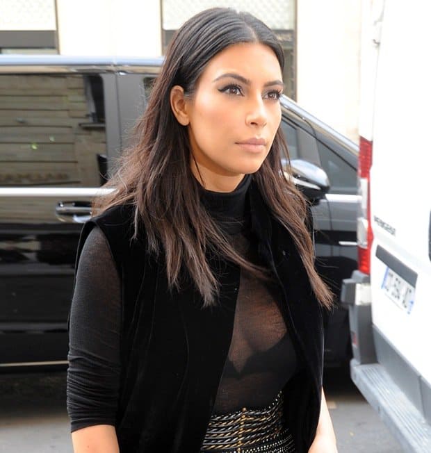 Kim Kardashian wearing a sheer top with a long velvet robe in Paris on September 29, 2014