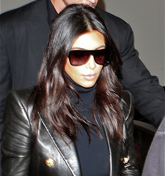 Kim Kardashian steps out at LAX in a sleek black leather jacket and oversized sunglasses