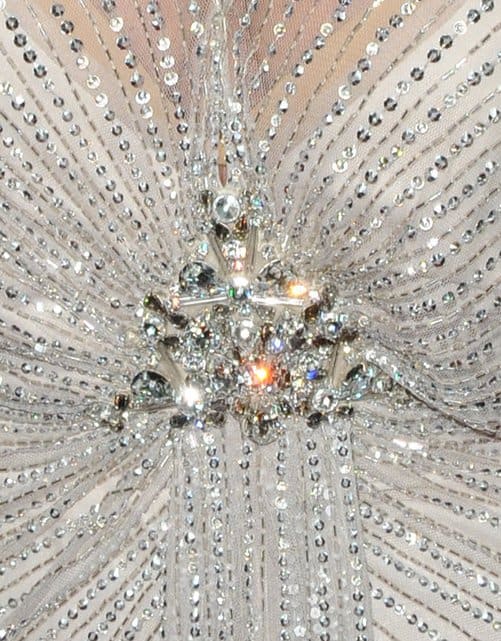Kris Jenner's beaded silver dress was embellished with a brooch-like jewelry piece