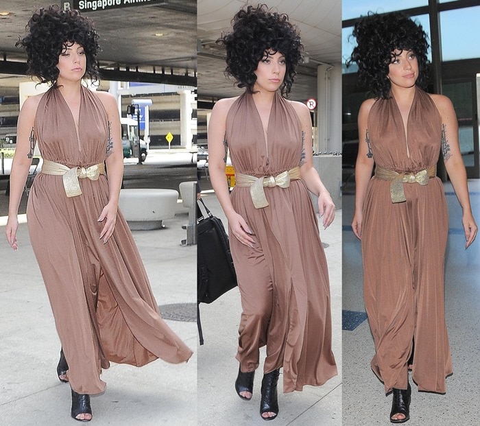 Lady Gaga showed off her tattoos in a sleeveless floor-length dress at LAX on October 14, 2014