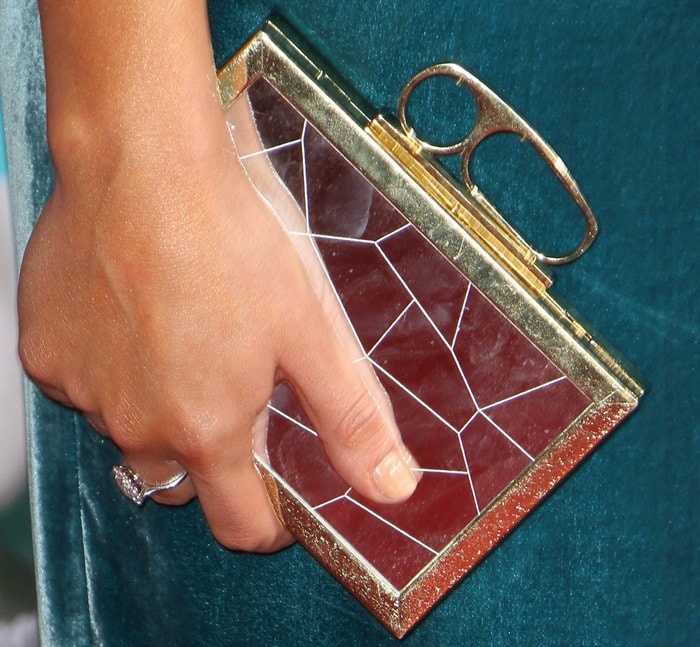 Lea Michele showcased a chic manicure in a natural nude shade, perfectly complementing her intricate gold clutch with its geometric design, while a sparkling ring added an extra touch of elegance