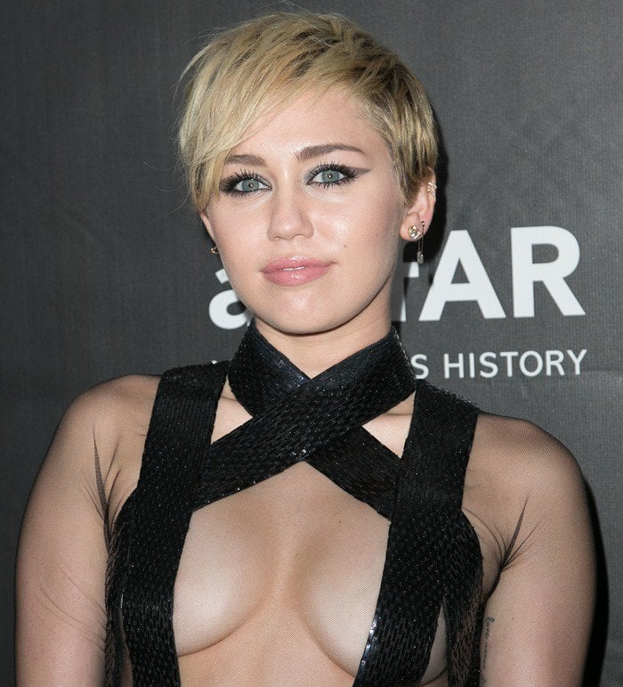 Miley Cyrus flaunts her boobs in a dress by Tom Ford that left her practically naked