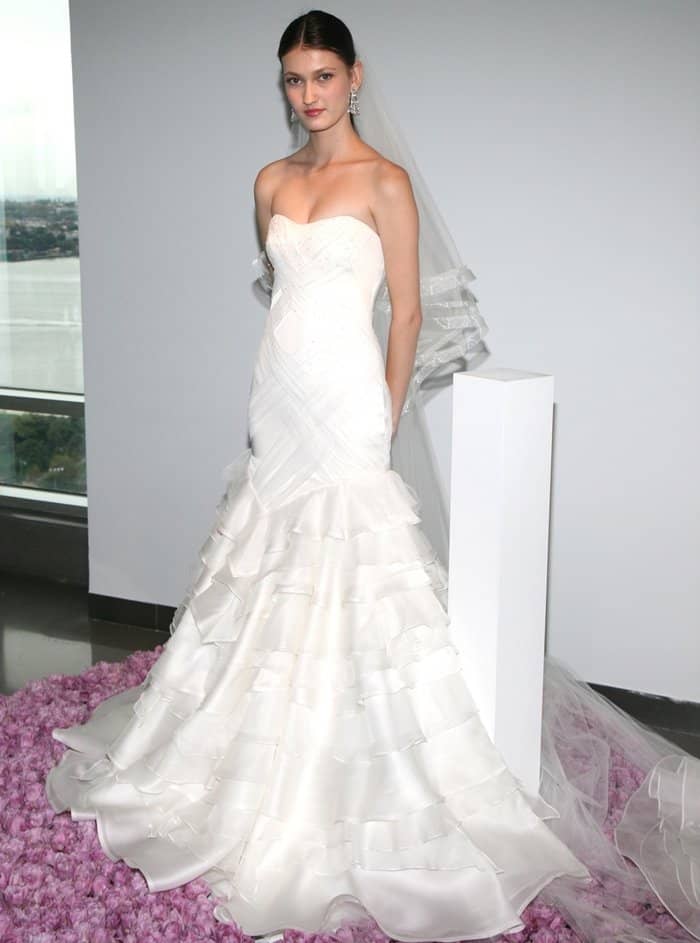 Pamella Roland's bridal collection features an exquisite wedding gown with ruffled chiffon layers and a sweetheart neckline