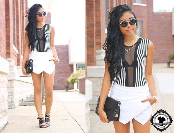 Sharena rocks a white origami skort and strappy gold-and-black sandals