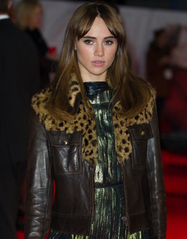 Suki Waterhouse wearing an ugly leopard print leather jacket with a metallic dress