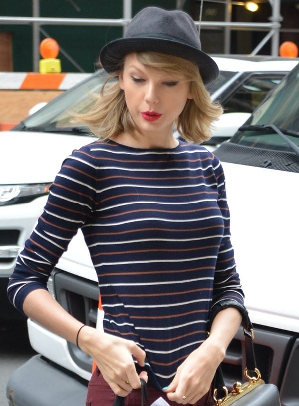 Taylor Swift wearing a striped Demylee sweater and a black fedora by Rag & Bone