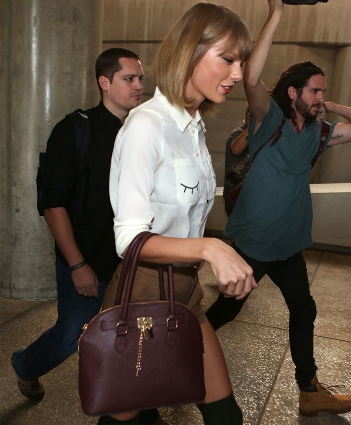 Taylor Swift paired her knee socks with a “Flitter Flutter” shirt by Miss Patina