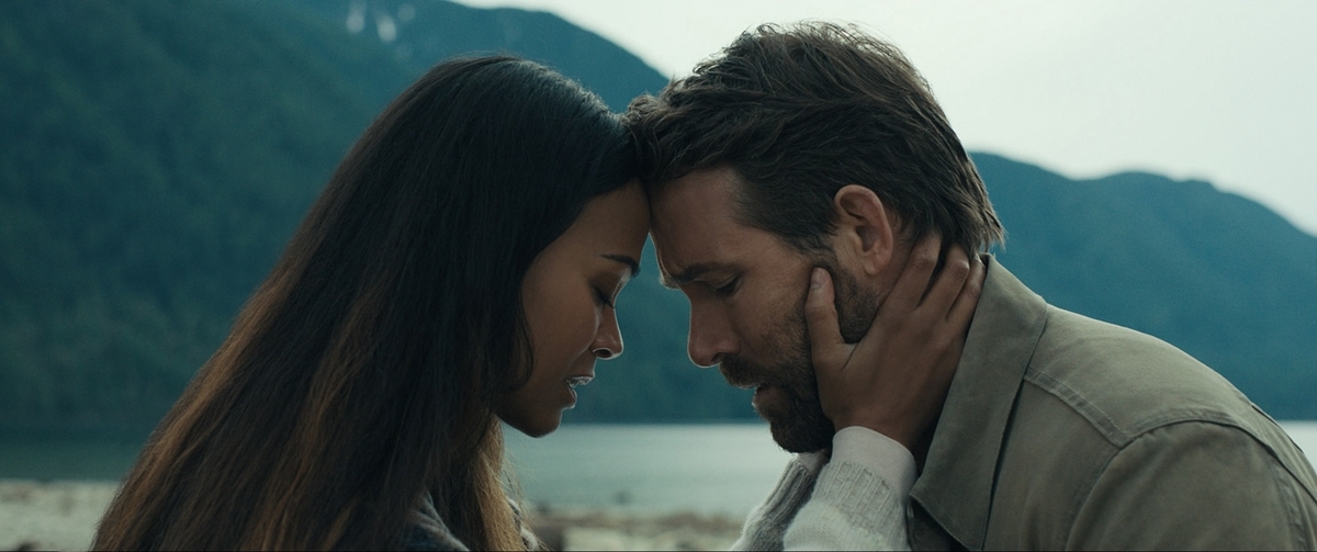 Ryan Reynolds as time pilot Adam Reed and Zoe Saldaña as his wife Laura Shane in the 2022 American science fiction adventure film The Adam Project