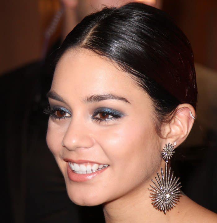 Vanessa Hudgens styled her smooth hair into an updo with a center part, accentuated with eye-catching sparkling Amrapali diamond star earrings