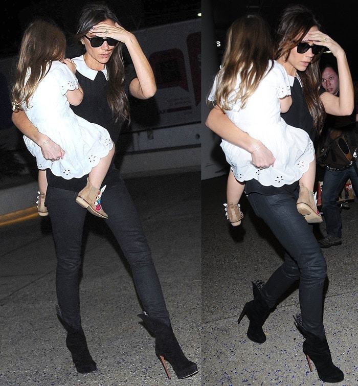 Victoria Beckham wearing skinny jeans, a black top with a round white collar, black sunglasses, and a pair of high heel ankle boots from Azzedine Alaïa
