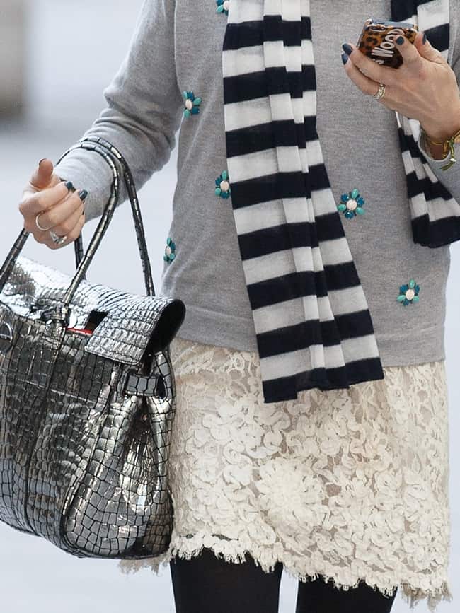 Fearne Cotton effortlessly blends a jeweled sweater, lace skirt, striped scarf, and metallic purse for a chic and eclectic look