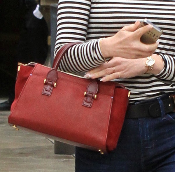 January Jones carries a red mini bag to complement her monochromatic outfit