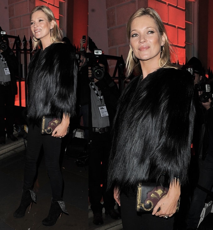 Kate Moss exudes effortless glamour in a luxe black faux-fur jacket, sleek skinny jeans, and statement leopard-print wingtip boots, complete with a gold-detailed clutch