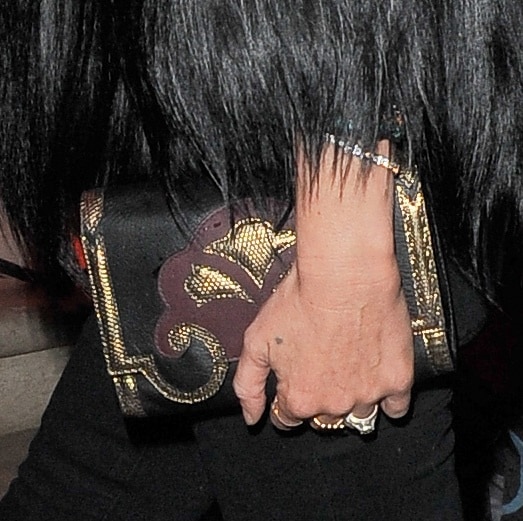 Kate Moss totes a gold-detailed clutch